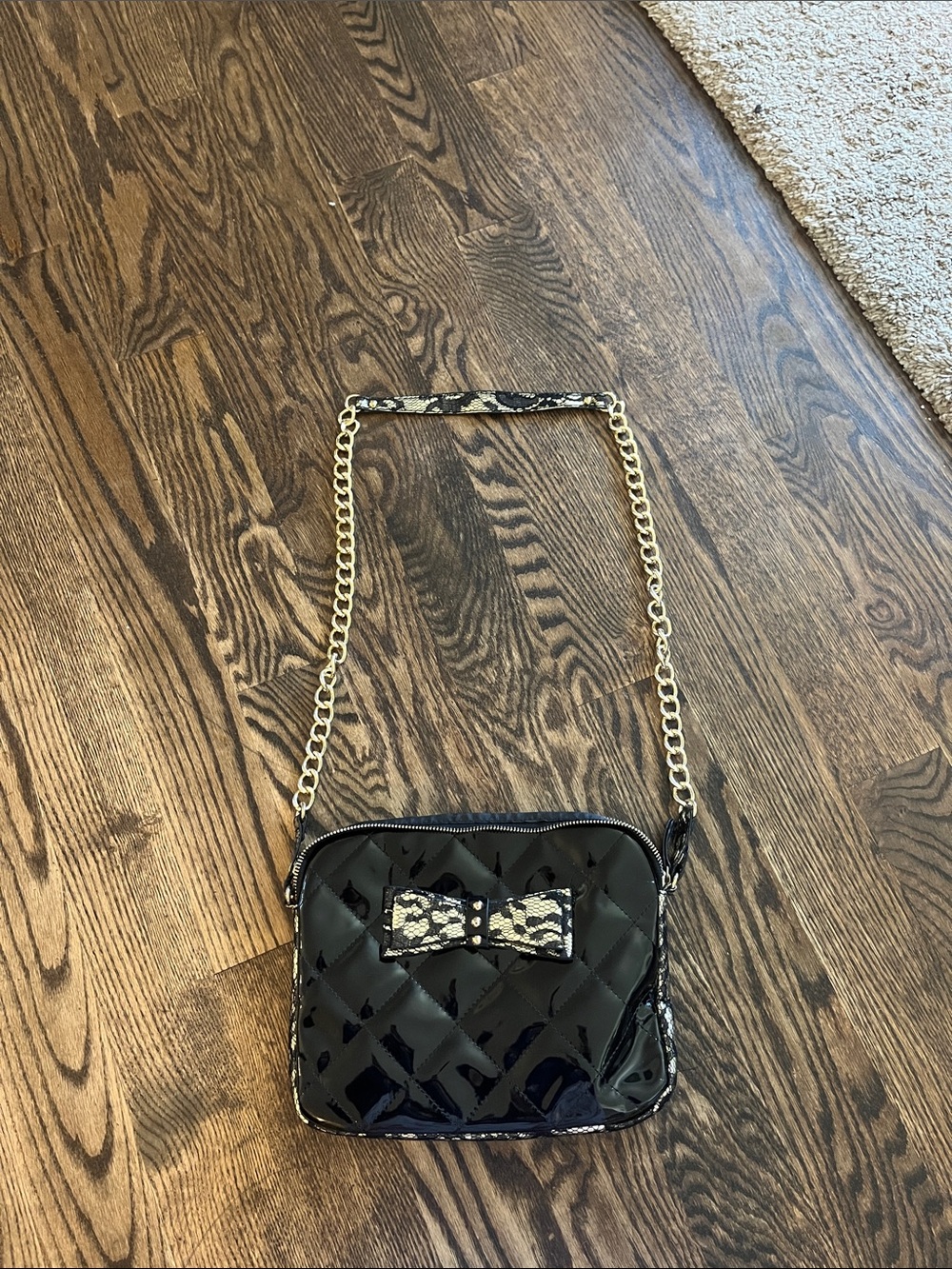 Black Quilted Patent Crossbody Bag with Bow Accent